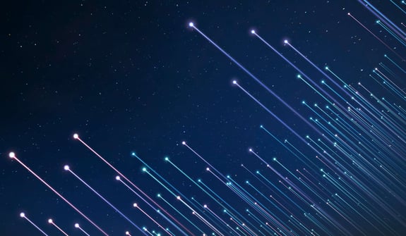 Abstract image of several beams of light with orbs at the end reaching upwards at an angle towards the dark blue night sky